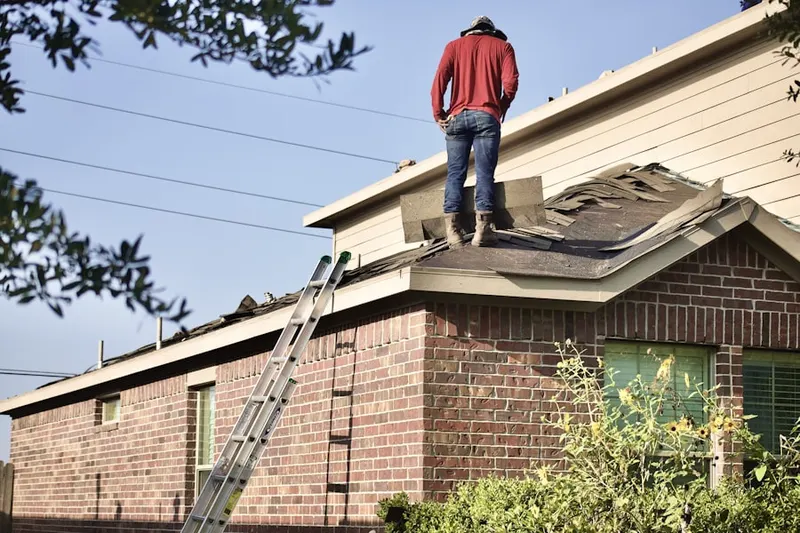 Professional roofer working on a residential roof in Clarksboro
